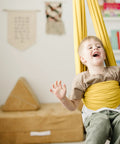 Child enjoying Indoor Outdoor Double Layer Cotton Sensory Swing For Kids With Special Needs Therapy And Vestibular Play