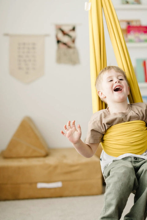 Child enjoying Indoor Outdoor Double Layer Cotton Sensory Swing For Kids With Special Needs Therapy And Vestibular Play