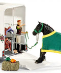 38 Piece Trailer And Truck Transporter Playset With Realistic Horse And Rider Figures Saddle Bridle Hay Bales And Accessories For Kids 5 And Up, featuring a Friesian horse with a green blanket approaching trailer.