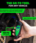 Rhino USA digital tire pressure gauge in close-up on tire valve; LCD backlit display, green handle, 150 PSI.