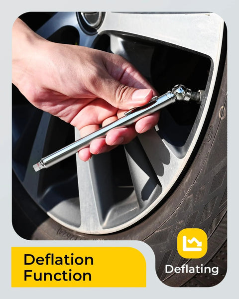 Installed pencil-style tire pressure gauge with stainless steel body on car tire valve; deflation function