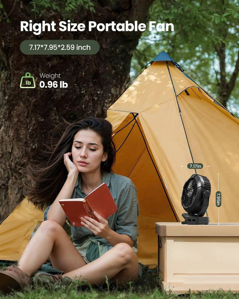 Woman reading by a tent with a Portable Camping Fan With LED Lantern, 360 Degree Rotation, Clip On For Desk Or Tent nearby.