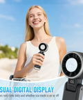 Woman holding Portable Handheld Turbo Fan With Ice Cooling Rechargeable Personal Fan Up To 12 Hours Of Cooling Five Speeds And 25550 RPM Turbo Wind Ideal For Travel Outdoor Adventures Camping And Hiking Black, close-up of digital display