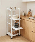 White 4 Tier Rolling Kitchen Cart With Pull Out Shelf Adjustable Middle Racks And Secure Locking Wheels Microwave Stand in kitchen with cookware.