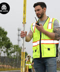 Built Tough Heavy Duty Reflective Safety Vest With 3M Tape And Reinforced Stitching Breathable Yellow Mesh Hella Visible For Construction Crews And Surveyors Zippered Front With Utility Pockets XL worn by man measuring on construction site.
