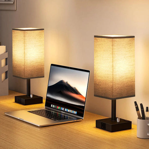 Black Fully Dimmable Nightstand Lamps Set Of 2 With USB C And USB A Ports, 2 AC Outlets, Square Linen Fabric Shade, on a desk