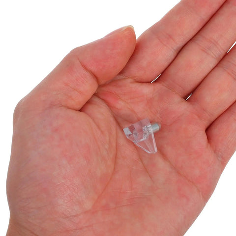 Close-up of a hand holding adjustable plastic and stainless steel peg from 100 Pack Shelf Pegs For Wardrobes And Cabinets