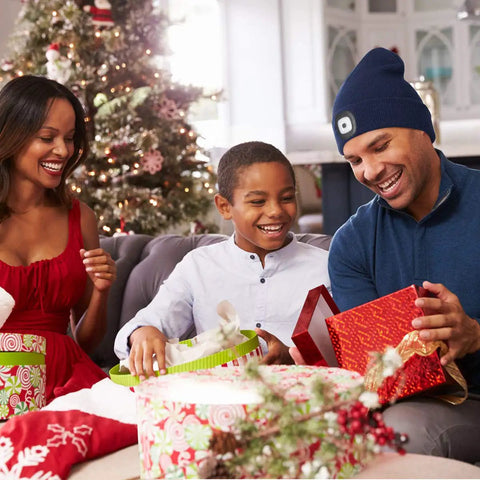 Family enjoying gifts with Light Up Beanie With Hands Free LED Light USB Rechargeable Knit Hat For Nighttime Outdoor Adventures.
