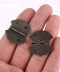 Antique Bronze Flower Pattern Hinges For Small Cabinets And Wooden Boxes, Decorative Butt Hinge With 4-Hole Mount, 29x32mm shown in hand
