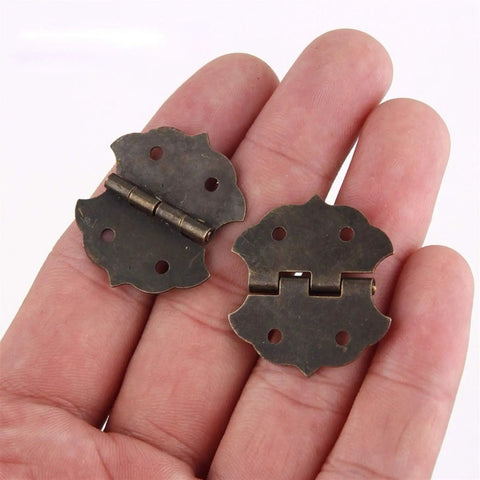 Antique Bronze Flower Pattern Hinges For Small Cabinets And Wooden Boxes, Decorative Butt Hinge With 4-Hole Mount, 29x32mm shown in hand