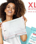 Smiling woman holding XL Shower Wipes For Adults No Rinse Bathing On The Go Clean Up Wipes showing size dimensions.