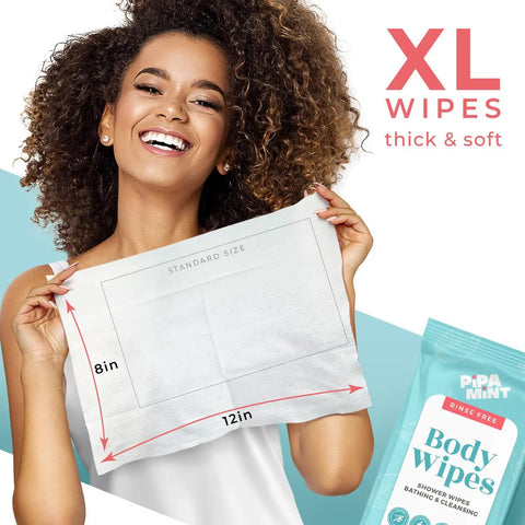 Smiling woman holding XL Shower Wipes For Adults No Rinse Bathing On The Go Clean Up Wipes showing size dimensions.