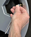 Hand using 20 Piece Must Have Air Tool Kit For Air Compressors With One Quarter Inch NPT Quick Connects Tire Gauge on wheel