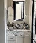 Pearl Shell Cabinet Knobs With Abalone Inlay on white vanity with marble countertop, featuring brushed gold pulls and accessories.