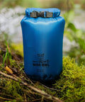Three Pack Waterproof Dry Bags Set 5L 10L 20L Lightweight Airtight Floating Gear Organizer For Kayaking Beach Travel Boating And Hiking Blue Ripstop Nylon Adventure Ready showing blue dry bag in forest.