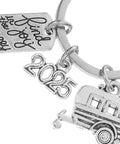 Close-up of Ultra Lightweight Zinc Alloy RV Key Chain with travel-themed design, featuring a camper and date charms, perfect for RV owners.