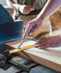 Dead On Precision Carpentry Scriber Mortise Marking Gauge used for marking measurements on a wooden plank in a workshop.