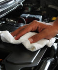 Cotton Shop Towels 14 By 12 Inches 145 Pack Reusable Cleaning Rags For Automotive Garage Workshop And Industrial Use White Durable Absorbent Lint Free Quick Clean Up Workhorse Towels being used to wipe a car engine.