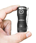 Hand holding Tiny But Mighty EDC Flashlight Rechargeable 1300 Lumens, Pocket Size, Keychain Friendly, IPX8 Waterproof