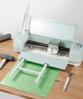 Cricut extension tray installed on mint Cricut Maker; white tray with a 12x12 green cutting mat.