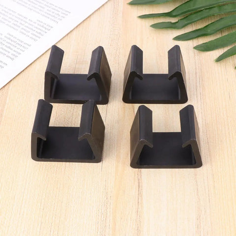 Four Pack Plastic Sectional Sofa Clips For Rattan Furniture on wood surface