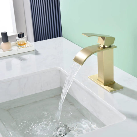 Side view of Waterfall Bathroom Faucet In Brushed Gold With Pop Up Drain And Deck Plate For 3 Hole Install in a modern sink