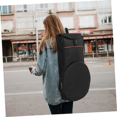 Road Warrior Portable Drum Bag Built Tough With Heavy Duty Oxford Fabric For Snare Drums And Percussion Gear Provides Waterproof Travel Storage Featuring Slick Quick Release Buckles To Keep Your Music Equipment Secure On Any Gig, worn on a person's back.