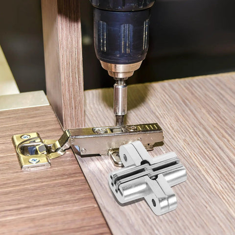 Installing Concealed Folding Cross Hinge For Wooden And Wardrobe Doors Stainless Steel with drill on wooden surface.