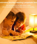 Children reading under Touch Activated Bedside Lamp With USB C And USB A Charging Ports Three Way Dimmable Black Finish