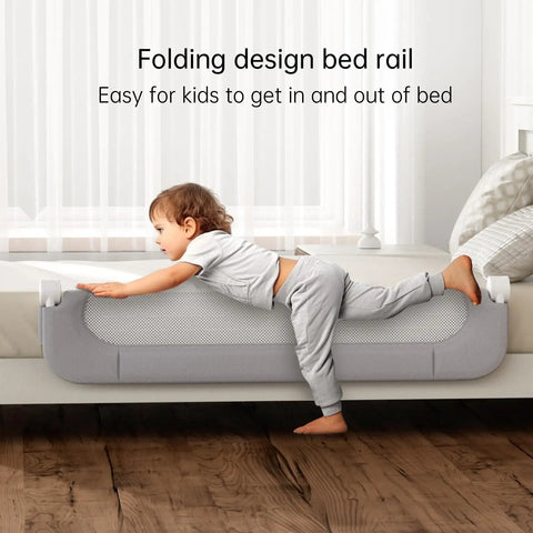 Foldable Toddler Bed Rail Guard With Bulletproof Anchor Strap And Zero Slide Base Design Heavy Duty Grey Toddler Barrier Rails For Tiny Humans Sleep Tight All Night Long with child getting in bed.