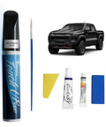 Black GBA WA8555 Touch Up Paint For GMC And Chevrolet Exact Match 2 In 1 Car Paint Pen with repair kit beside a black truck