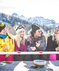 Rustic White Wooden Ski Shot Board Set For Four Players Pub Trivia Drinking Game With Fifty Marked Cups And Included Marking Pen in use outdoors.