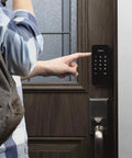 Person using Touchscreen Smart Door Lock With Keypad And Bluetooth Motorized Deadbolt One Tap Entry Easy Setup Remote App Control See Who Entered And When 20 Unique Access Codes Black DB1 on wooden door