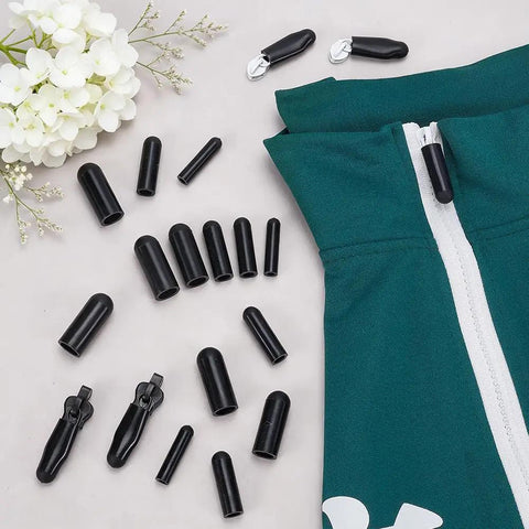 Image shows a 25 Piece Silicone Zipper Protector Covers Guards Set For Laundry Care Includes Five Universal Sizes In Black next to a green fabric with a zipper.