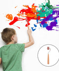 Boy using a Professional Heavy Duty Rubber Ink Roller For Printmaking And Canvas Painting Smooth Glide Surface on a wall.