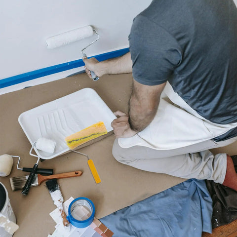 Person using a Heavy Duty Cotton Thread Paint Roller With Zero Hassle Grip And Smooth Roll Action on a wall.