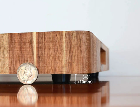 Side view of a wooden cutting board elevated by Non Slip Rubber Feet For Cutting Boards With Stainless Screws 12 Pack, showing height.
