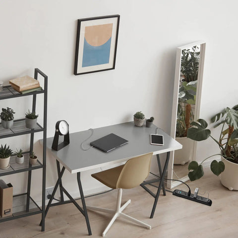 Office setup with 3ft Black Power Strip Tower Surge Protector with 6 Outlets and 300 Joule Rating on floor beside desk.