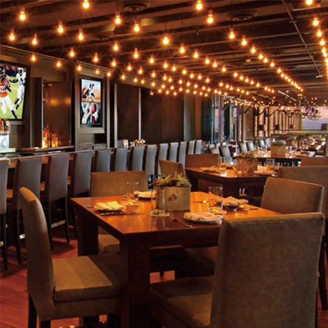 Warm lit restaurant with G40 Replacement Light Bulbs 120V 5W Warm White E12 Candelabra Base Dimmable Clear Glass Globe Edison Style 25 Pack