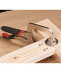 Rock Solid Pocket Hole Jig Face Clamp For Seamless Frame Joinery Featuring Adjustable Pressure and Lightning Fast Quick Release Lever for Dead Nuts Perfect Seams On Flat Woodwork Pieces with durable steel body on wood surface.