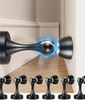 Six Pack Magnetic Door Stops Heavy Duty Stainless Steel Black Finish Wall Or Floor Mount Keeps Doors Open Prevents Slams Protects Walls Hands Free When Carrying Items, showing one installed on wall.