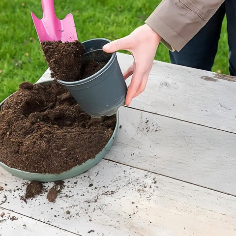 Mini Colorful Metal Hand Shovels Set 10 Pack Garden Trowels For Kids Teens And Adults Perfect For Flower Soil Planting Digging And Transplanting 11 By 3 Inches Durable Metal Garden Tools being used to fill a plant pot with soil.