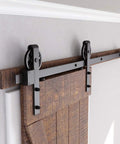 Beefy Heavy Duty Sliding Barn Door Hardware Kit 5ft Black With Pull Handle Set And Floor Guide Fits 30 Inch Wide Door Panel Big Industrial Wheel Hangers Supports Up To 220 Lb installed on wooden door