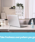 Odor Eliminator Spray 8 Oz Lightly Scented Pump Bottle for Bathroom Home Pets on a desk beside laptop.
