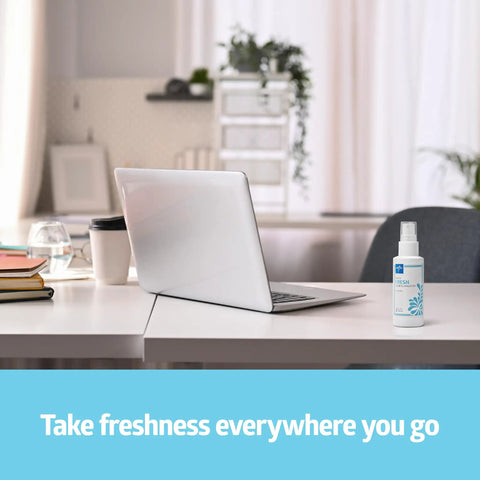 Odor Eliminator Spray 8 Oz Lightly Scented Pump Bottle for Bathroom Home Pets on a desk beside laptop.