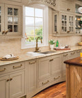 Kitchen with Antique Brass Cabinet Knob Set Six Pack Vintage Bronze Drawer Pulls on cream cabinets and wooden island.