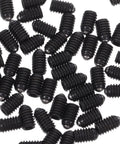Rock Solid M4x6 Stainless Steel Ball Point Spring Plunger Set Screws 50 Pieces, black coated screws scattered on a white background.