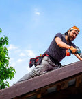 A DIY enthusiast using a drill on a rooftop, wearing safety gear. Partial view of 22 Piece Titanium Screw Extractor Set For Stripped Screws And Bolts.