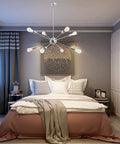 Sputnik Chandelier Light Fixture Chrome Finish Eight Light Ceiling Lamp for Living Room and Dining Room Modern Retro Style with Bright Ambient Illumination and a Totally Lit Satellite Design hanging over a bed in a modern bedroom.