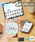 Person holding a Bluetooth Sticker Printer Mini Portable Sticker Maker With 3 Roll Paper Inkless Thermal Printing For iPhone in a hand.